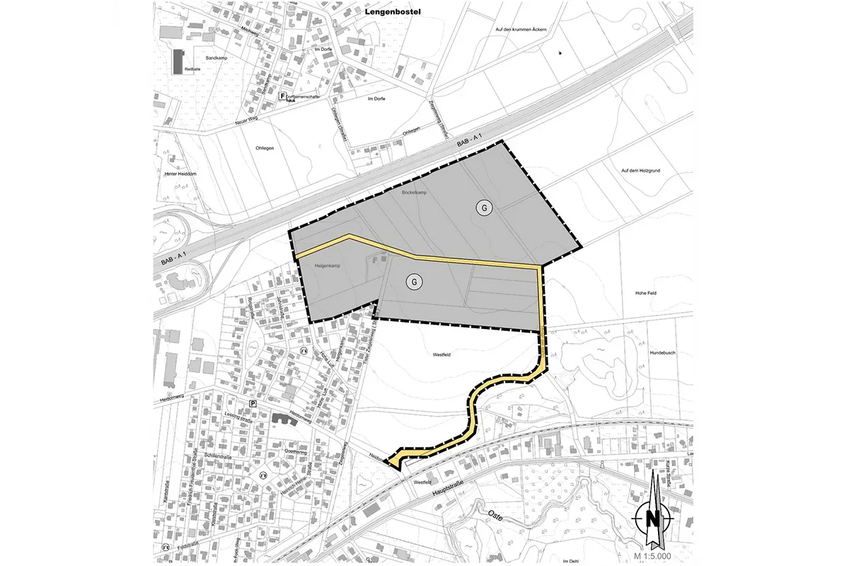 Site plan with two grey parcels enclosed by a dashed black boundary; a yellow access road winds through the area amid surrounding streets and buildings; north arrow visible at bottom-right.